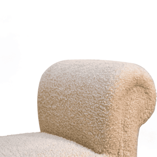 Close-up of the bench's rolled armrest, highlighting the soft beige upholstery.