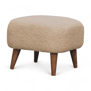 Angled left view of the Beige Upholstered Ottoman highlighting its soft upholstery and natural wood legs.