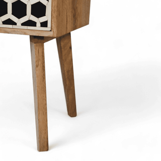 Close-up of tapered wooden leg on mid-century mango wood nightstand with honeycomb bone inlay, showcasing sturdy and elegant design