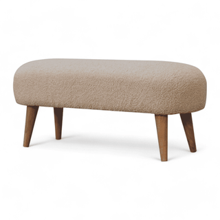 Angled left view of the boucle cream bench highlighting the modern silhouette and cream upholstery.