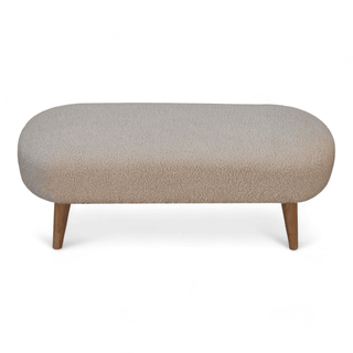 Front angled view of the boucle cream bench, showcasing its textured upholstery and minimalist design with wooden legs.