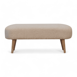 Front view of the boucle cream bench showcasing its smooth, rounded design and sturdy wooden legs.