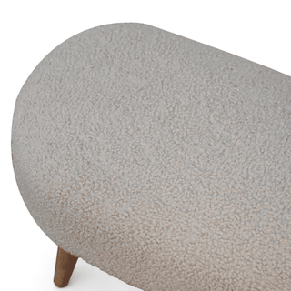 Top view of the boucle cream bench highlighting its rounded rectangular shape and spacious seating. 