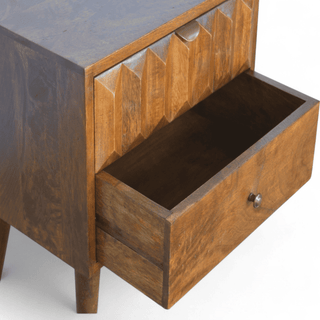 Open drawer view of carved prism mango wood nightstand, showcasing smooth drawer functionality and spacious storage space