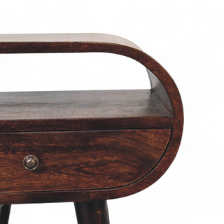 Close-up of the top surface and curved edges of the dark wood nightstand, showing its sleek finish.