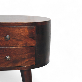 Close-up view of the two drawers on the round walnut nightstand, featuring metal knobs and a dark wood finish.