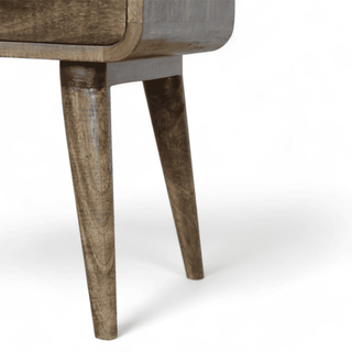 Close-up of the Scandinavian-style legs of a grey-washed mid-century modern nightstand, highlighting their smooth wooden texture and tapered design.