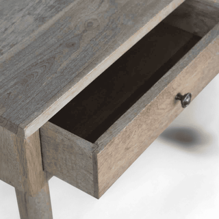 Close-up view of the console table with one drawer open, revealing smooth storage functionality and natural wood details.