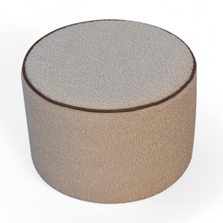 Top angled view of the Cream Bouclé Ottoman with a textured cream surface and contrasting edge detail, highlighting its cylindrical shape.