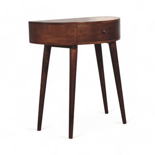 Right-angled view of a dark wood console table with a rounded oval design, single drawer, and tapered legs.
