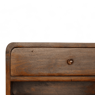 Close-up view of floating nightstand’s drawer front, showcasing a retro-style round knob and smooth wooden texture