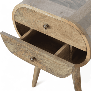 Drawer mechanism of an oval bedside table, showing the spacious compartments crafted from solid mango wood.