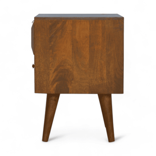 Side view of mid-century mango wood nightstand, highlighting its clean lines, smooth finish, and geometric carved drawer design