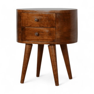 Angled view of round mango wood nightstand showcasing its smooth curved edges, two drawers, and tapered Nordic-inspired legs