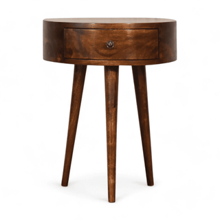 Front view of a mid-century modern round wood side table with single drawer and sleek tapered legs, crafted from mango wood in a chestnut finish.