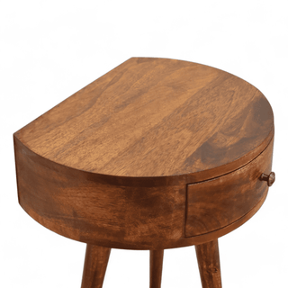 Top-down view of the round mango wood side table, emphasizing its smooth, rounded surface and rich chestnut finish.