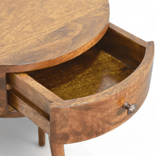 Close-up view of the open drawer on the round wood side table, showcasing its spacious storage and craftsmanship.