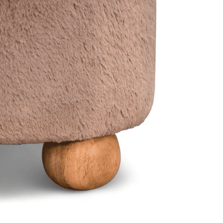 Underside view of the round footstool, showcasing its wooden ball legs and durable base.