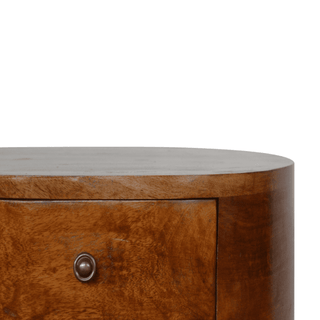 Close-up of drawer front on mango wood nightstand, highlighting its rich chestnut finish and retro-style knob detail