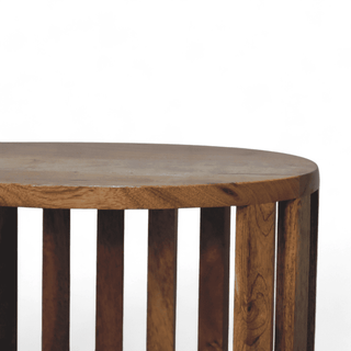 Close-up of the top edge of round mango wood nightstand, showcasing rounded corners and artisan craftsmanship