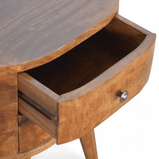 Open drawer view of round mango wood bedside table, showcasing spacious storage and smooth sliding mechanism